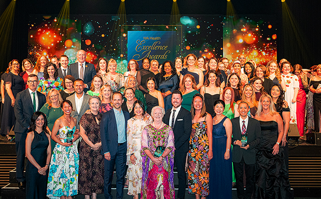 Group of people standing on a stage, the winners of the 2025 WA Health excellence awards.