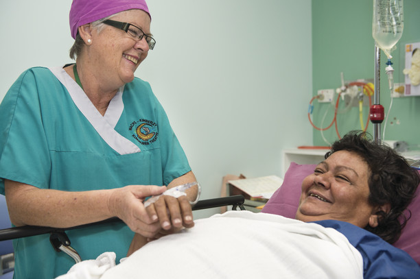 Nurse attending patient at their bedside