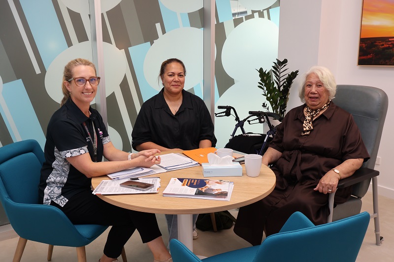 South Metropolitan Health Service Social Worker, Rose, with patient Mele, and her daughter and carer, Mele Junior, sitting at a round table.