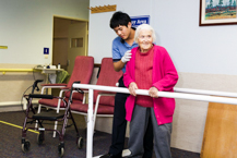 Elderly Patient attempting to walk again during rehabilitation session
