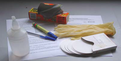 Standard test kit with gloves, water, pen, permanent marker, sealable plastic bags and filter papers
