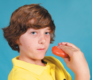 Child moving accuhaler towards mouth