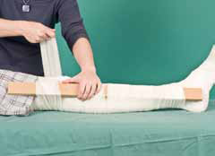 Splint being bandaged to leg