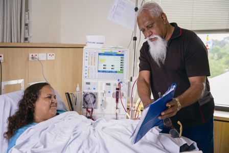 Female patient in hospital reviewing consent with her carer
