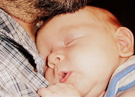 Baby sleeping on fathers chest