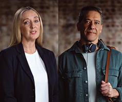 Lady and a man standing in front of a brick wall